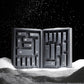Ein rechteckiger Dermalogica Premium-Adventskalender 2026 mit nummerierten Fächern steht offen und aufrecht im Schnee, während vor schwarzem Hintergrund Schneeflocken fallen – eine ideale Möglichkeit, Ihre Hautpflege-Routine während der festlichen Jahreszeit auf ein neues Niveau zu heben.