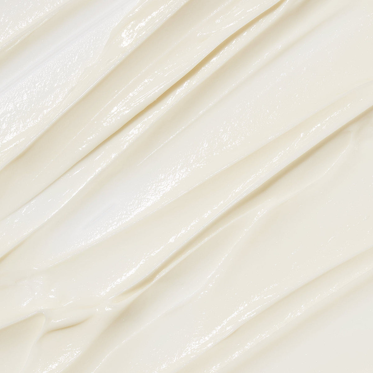 Nahaufnahme der glatten, cremigen, cremefarbenen Anti-Aging-Formel mit glänzender Textur und sanften Falten - die luxuriöse Phyto Nature Lifting Eye Cream + Phyto Nature Oxygen Cream.